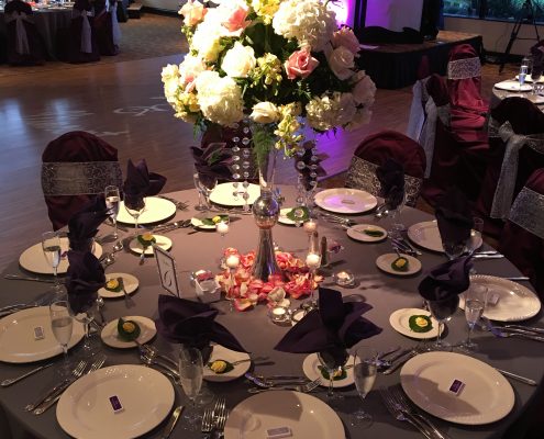 A dinning table decorated with a flower pot