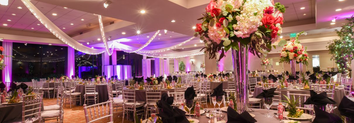 A dinning table decorated with flowers and fruits