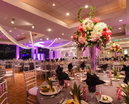 A dinning table decorated with flowers and fruits