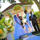 Outdoor wedding ceremony at a gazebo with bride, groom, and officiant