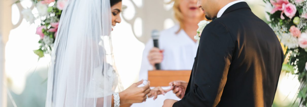 A groom and bride wearing rings